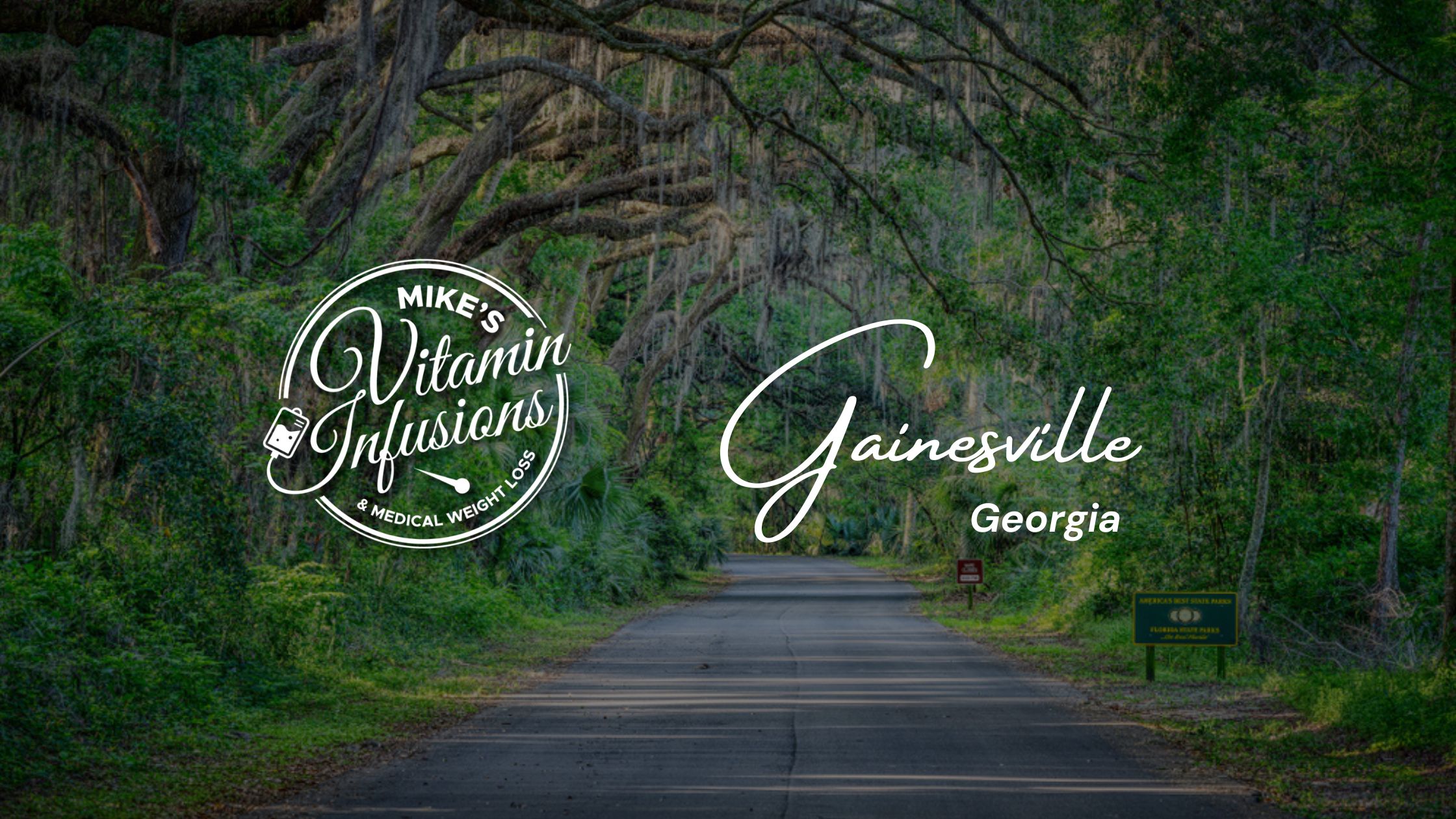 Image of a road with green trees in Gainesville Georgia with the mike's vitamin infusions logo